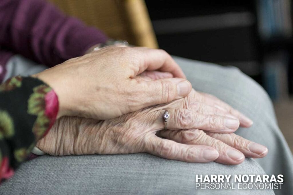 The Care Economy article feature image of elderly couple holding hands